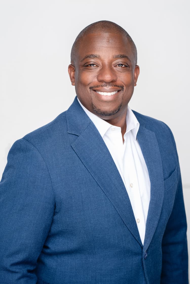 A professional portrait of Brian Benjamin